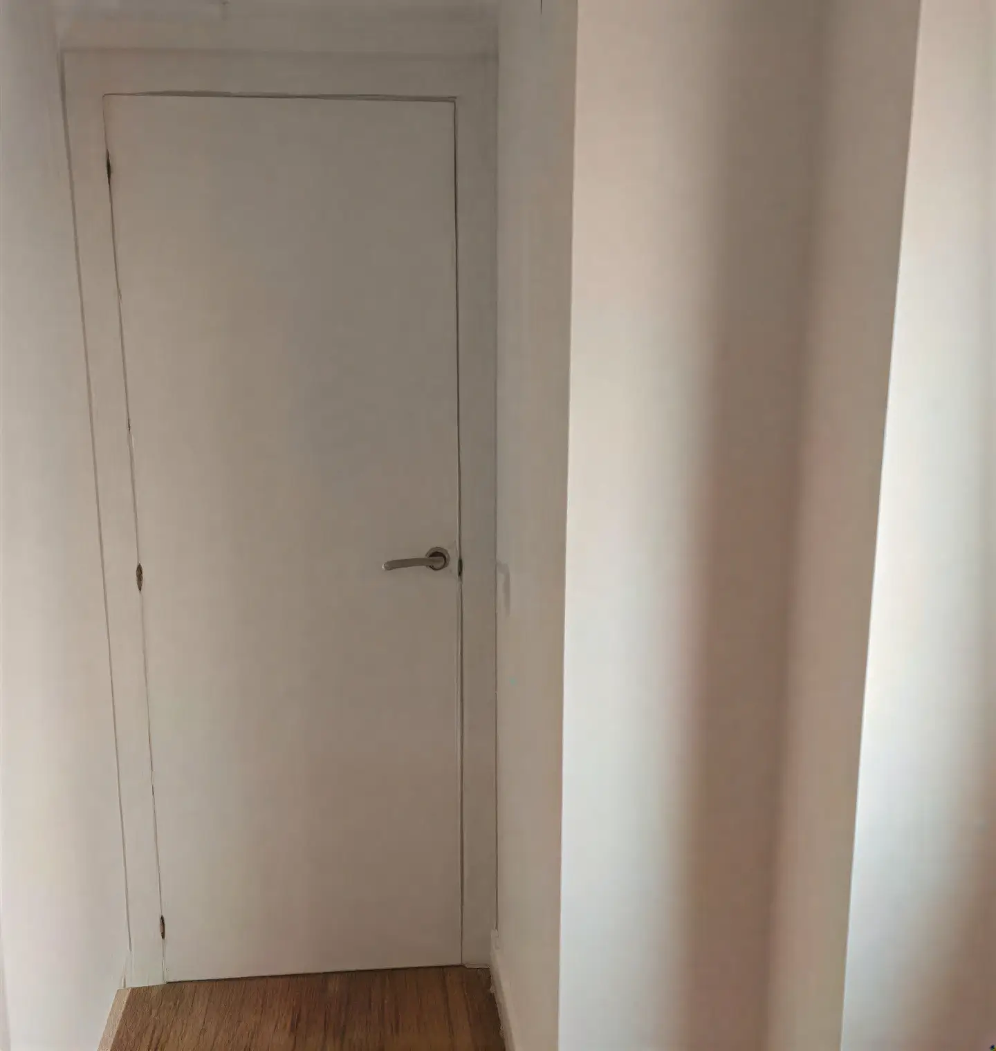 Puerta interior lacada en blanco en pasillo realizada por Los Pintores Cáceres